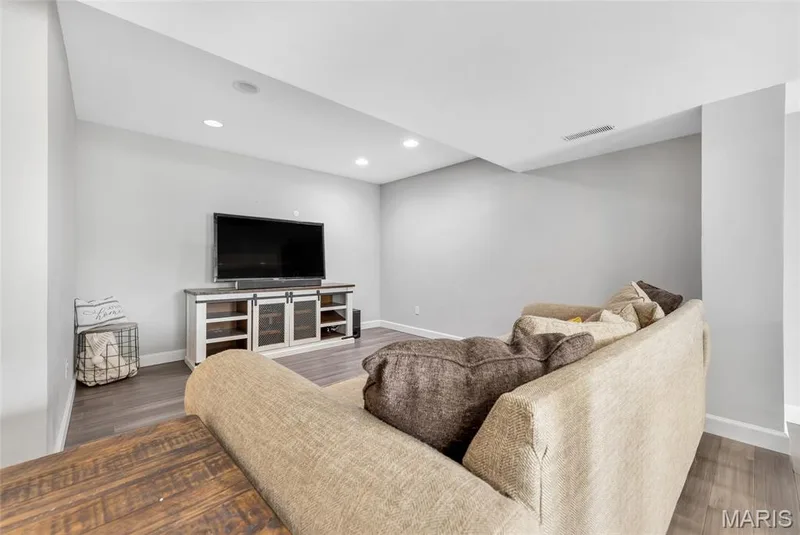 Recessed lighting illuminating a spacious room with bamboo flooring — 501 Oxborough Court, Cottleville, MO 63376