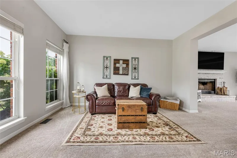 Bright living area featuring abundant natural light from multiple windows — 501 Oxborough Court, Cottleville, MO 63376