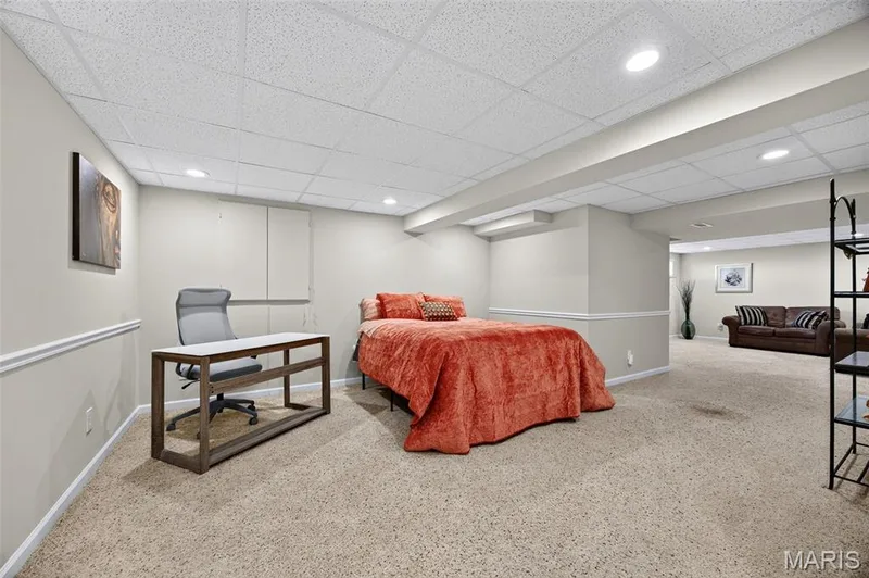 Carpeted lower level featuring recessed lighting, a drop ceiling, and chair rail molding — 30 Hunting Manor Drive, St Charles, MO 63303