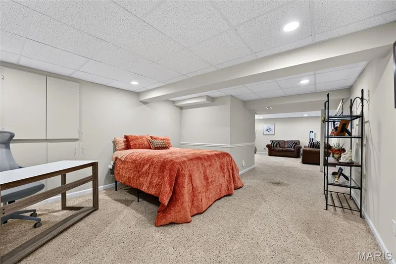 Expansive carpeted room featuring recessed lighting, a drop ceiling, and neutral wall tones — 30 Hunting Manor Drive, St Charles, MO 63303
