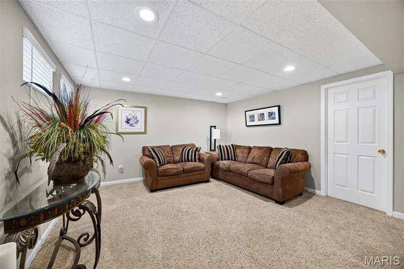 Carpeted room featuring a white paneled door, recessed lighting, and white horizontal blinds — 30 Hunting Manor Drive, St Charles, MO 63303