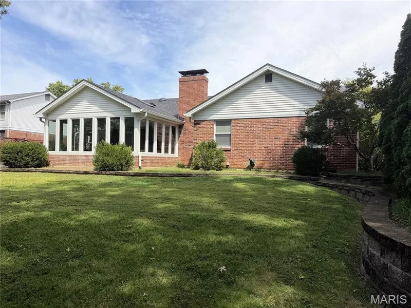 Brick exterior with a prominent chimney and white siding accents — 14238 Kinderhook Drive, Chesterfield, MO 63017