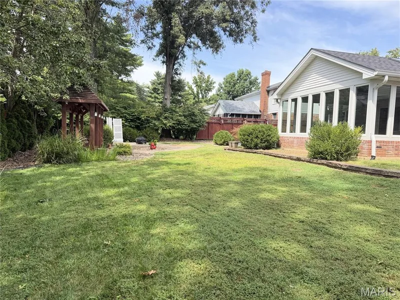 Expansive backyard featuring a manicured lawn, established trees. — 14238 Kinderhook Drive, Chesterfield, MO 63017