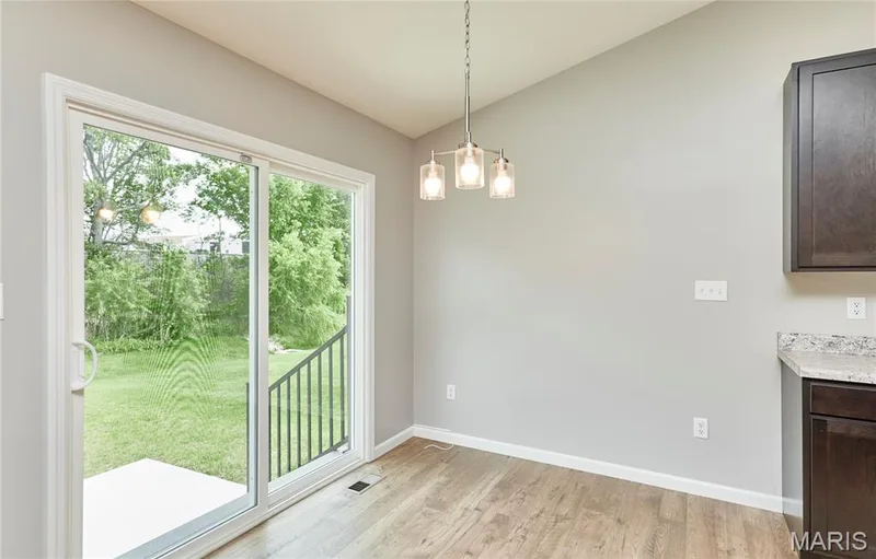 The breakfast room with double doors leading to the expansive new patio area. — 133 Day Lily Lane, Wentzville, MO 63385