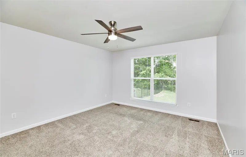 The Primary bedroom with beautiful modern ceiling fan. — 133 Day Lily Lane, Wentzville, MO 63385