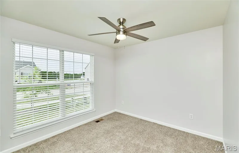Bedroom #2 with light and bright window and modern ceiling fan. Blinds on all windows, too! — 133 Day Lily Lane, Wentzville, MO 63385