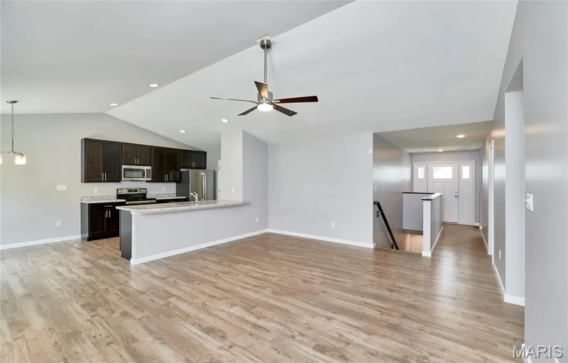 Beautiful Luxury Vinyl Plank flooring enhances this large open area from the entry through the Great Room and Kitchen! — 133 Day Lily Lane, Wentzville, MO 63385