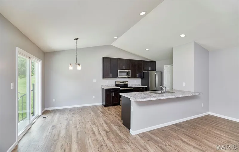 Looking to the large Vaulted kitchen area and breakfast bar. — 133 Day Lily Lane, Wentzville, MO 63385