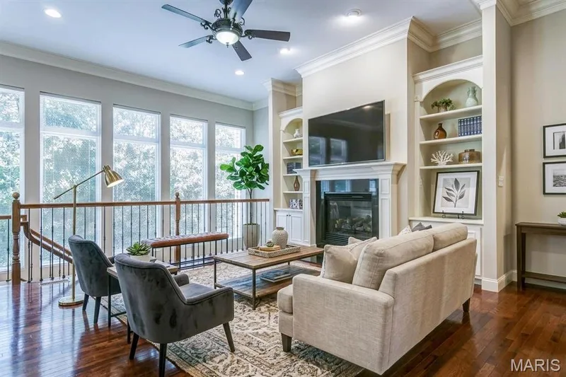 Efficient gas fireplace flanked by custom shelving. To show all off, towering 12 foot great room ceiling. — 1209 Silver Fern Drive, Lake St. Louis, MO 63367