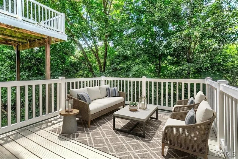 Lower deck.Upper deck shown upper left. The private lot backing to trees is on everyone's wish list. Best of all, an atrium wall of windows! — 1209 Silver Fern Drive, Lake St. Louis, MO 63367