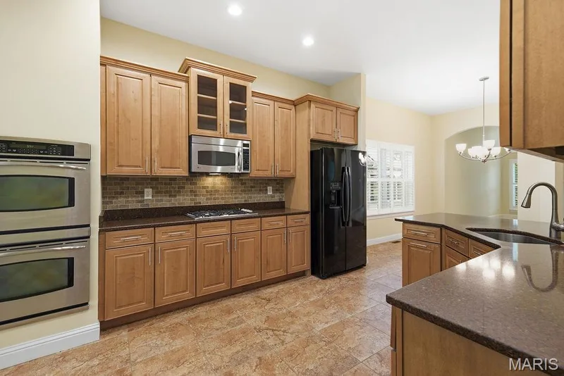 Kitchen offers maple cabinets, granite counters — 14 Burgundy Place Drive, Dardenne Prairie, MO 63368