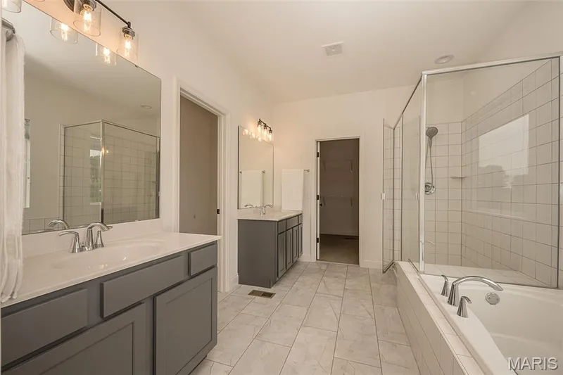 Primary luxury bathroom with double vanities and separate tub and shower — 325 Gailin Drive, Lake St. Louis, MO 63367