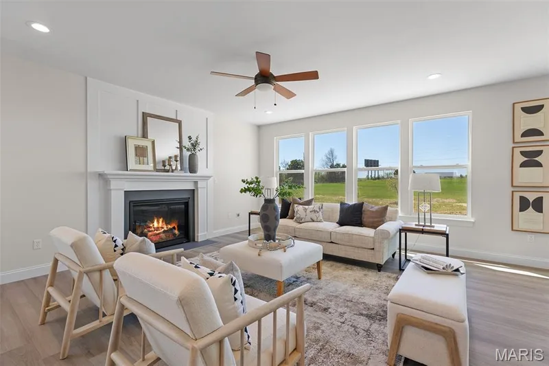 Great Room with view of Electric Fireplace, ceiling fan and window wall — 305 Healthy Way, St Charles, MO 63304