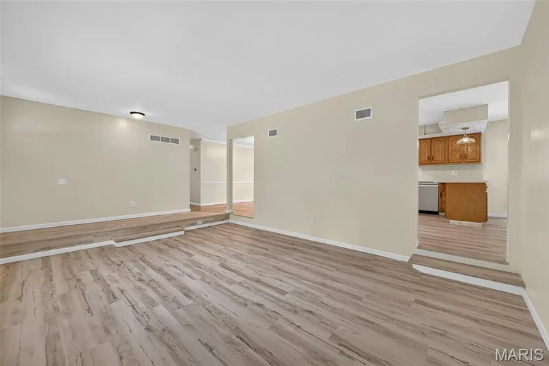 Living room connects to both dining room and kitchen — 208 Meadowlark Lane, St Charles, MO 63301