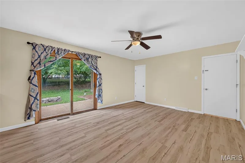 Sliding glass door to fenced in back yard off the hearth room. Basement and garage access off the door in the right of the photo. — 208 Meadowlark Lane, St Charles, MO 63301