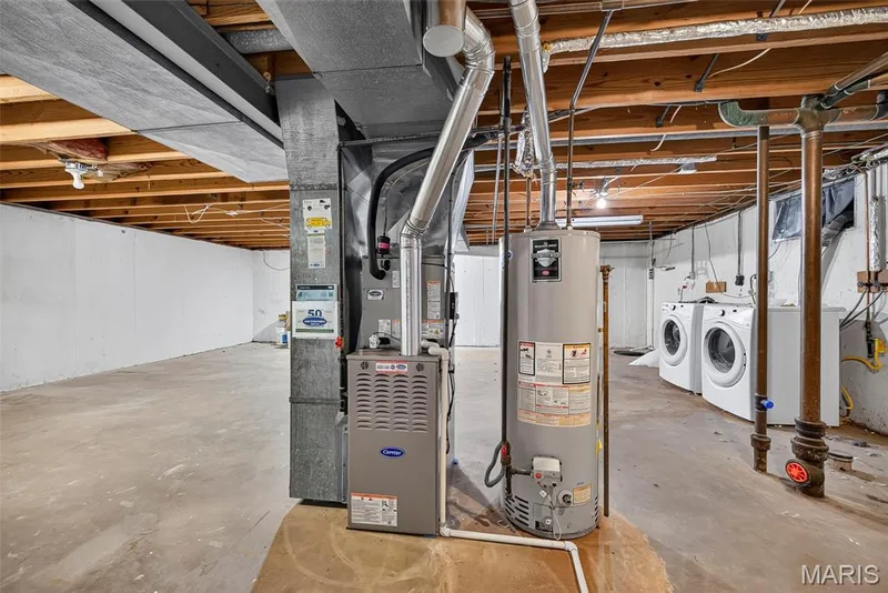 Laundry is located in unfinished basement with plenty of storage space and new HVAC 7/26 — 208 Meadowlark Lane, St Charles, MO 63301