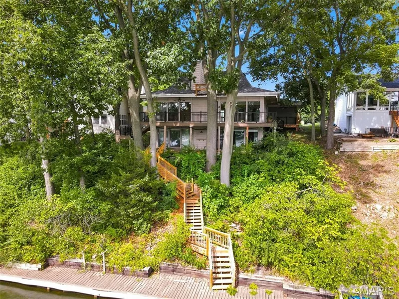 Waterfront Home with newer steps with handrail leading to the private dock and boardwalk along the retaining wall on the back of the .36 Acre Waterfront Lot on Lake Saint Louis. — 4 Harbor Point Court, Lake St. Louis, MO 63367