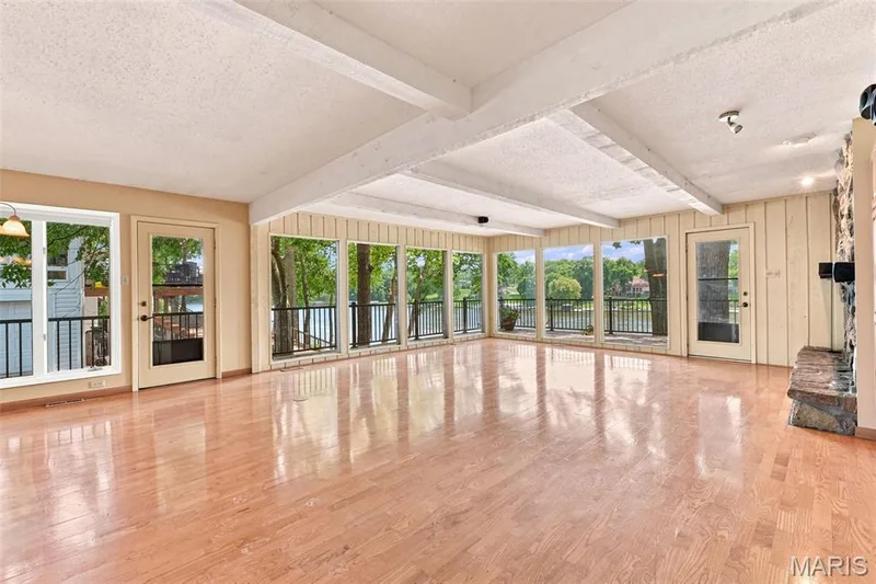 See Virtually Staged picture for your imagination.  Great Room with Beamed Ceiling and Stone Gas Fireplace in this open floor plan to the dining area and kitchen. — 4 Harbor Point Court, Lake St. Louis, MO 63367