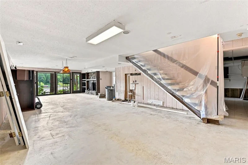 Walkout Lower Level with a family room, wood burning fireplace, rough-in wet bar, full bathroom rough-in, bedroom #4 and large laundry room area. — 4 Harbor Point Court, Lake St. Louis, MO 63367