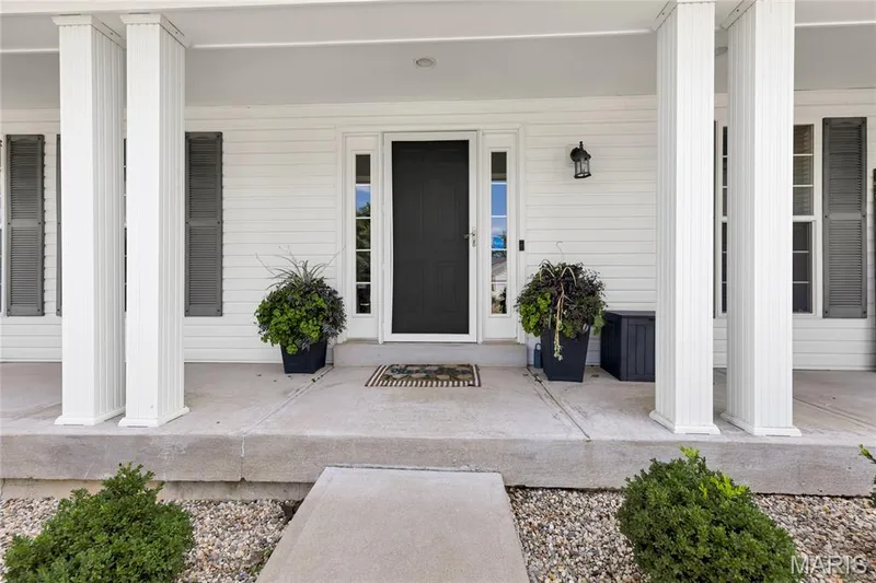 A welcoming covered front porch that measures 4x32 greets you home. — 2304 Bear Fountain Run, Wentzville, MO 63385
