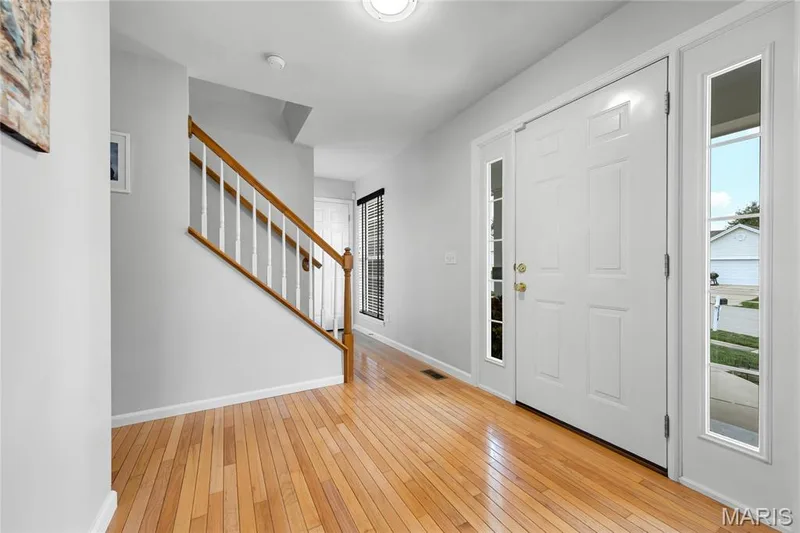 Gleaming hardwood floors can be found upon entering the home.  This space is inviting with natural light and also has a entry closet. — 2304 Bear Fountain Run, Wentzville, MO 63385