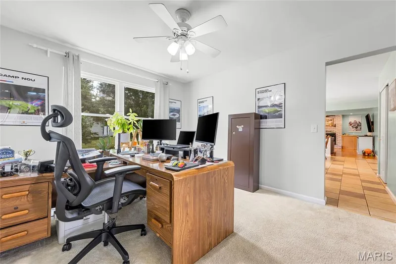 Spacious formal dining room, currently used as a home office, has ease of access to the kitchen and views of mature trees in the back yard. — 2304 Bear Fountain Run, Wentzville, MO 63385