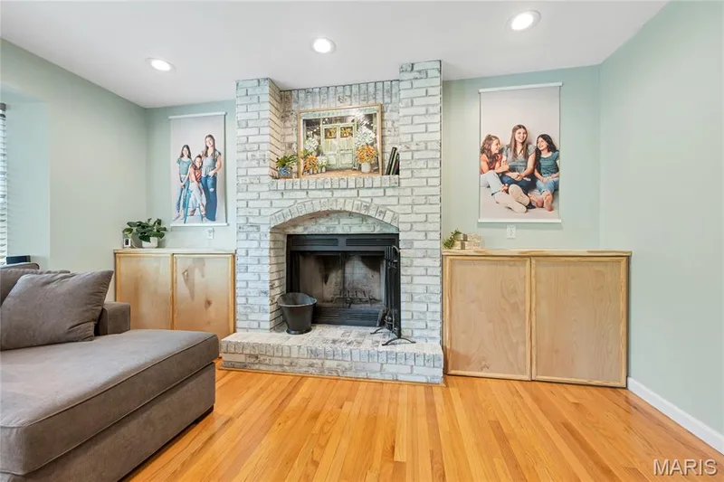 White washed brick wood burning fireplace with additional storage on either side is a great focal point in the living room — 2304 Bear Fountain Run, Wentzville, MO 63385