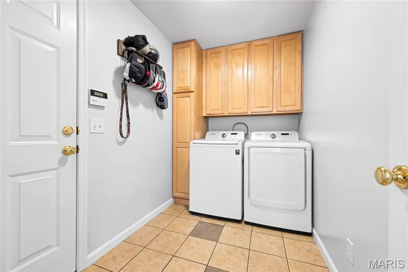 Main floor laundry can double as a drop zone when coming in from the 3 car garage. — 2304 Bear Fountain Run, Wentzville, MO 63385
