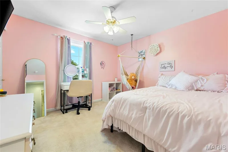 Carpeted bedroom featuring a ceiling fan and views towards the front of the house — 2304 Bear Fountain Run, Wentzville, MO 63385