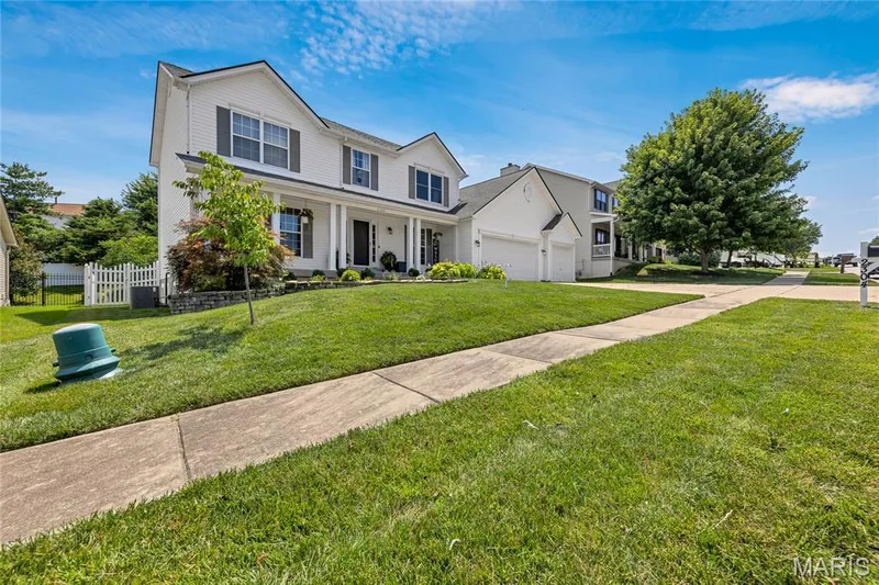 Side profile of Bear Fountain Run shows mature landscaping. — 2304 Bear Fountain Run, Wentzville, MO 63385