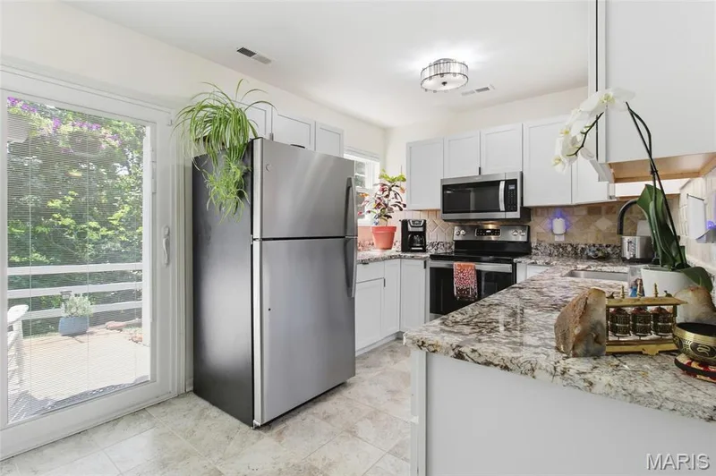 slider from the kitchen to the covered porch and storage area — 16566 Victoria Crossing Drive #B, Wildwood, MO 63040