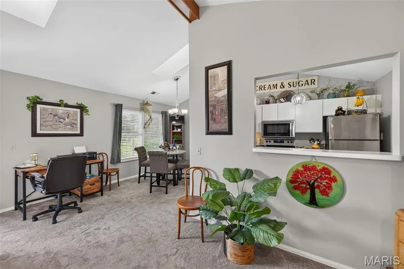 Open-concept living area with vaulted ceiling and skylights — 974 Windstream Drive #38, St Peters, MO 63376