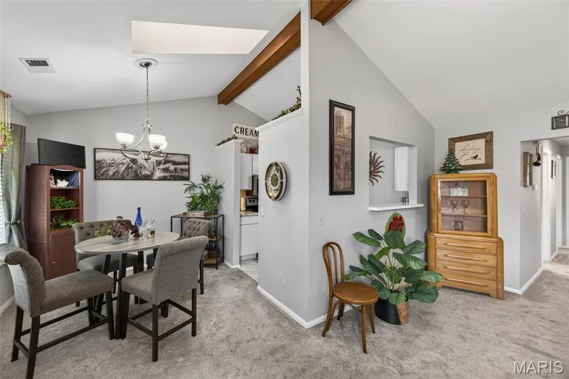 Vaulted ceilings featuring exposed wood beams and a skylight — 974 Windstream Drive #38, St Peters, MO 63376
