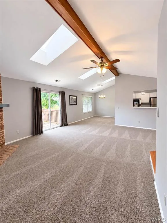 Vaulted ceiling with skylights and exposed wood beams — 974 Windstream Drive #38, St Peters, MO 63376