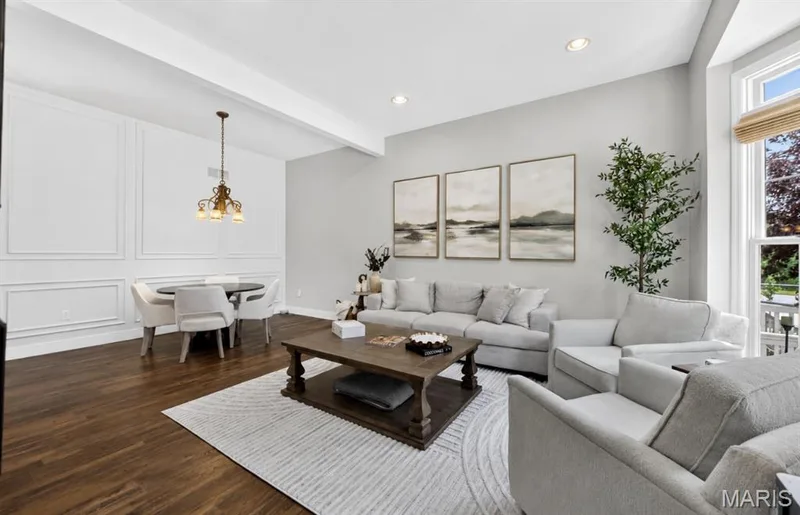 Spacious living area featuring rich wood-finish flooring and recessed lighting — 2514 S Larksong Drive, Grover, MO 63040