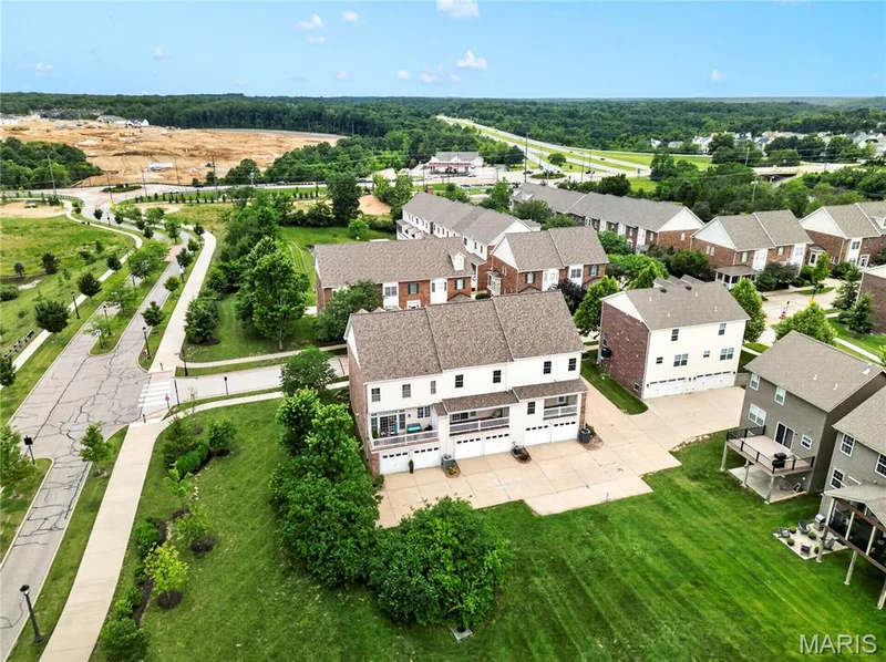 Aerial overview featuring multiple multi-story residences with attached garages and rear decks — 2514 S Larksong Drive, Grover, MO 63040