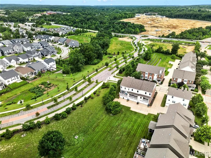 Aerial perspective of a developed residential area featuring multiple housing styles — 2514 S Larksong Drive, Grover, MO 63040