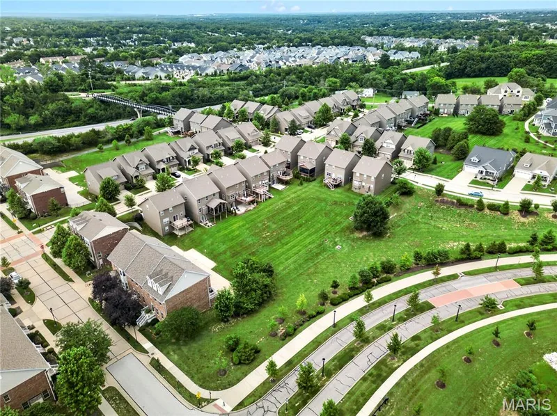 Expansive residential development featuring varied architectural styles and mature landscaping — 2514 S Larksong Drive, Grover, MO 63040