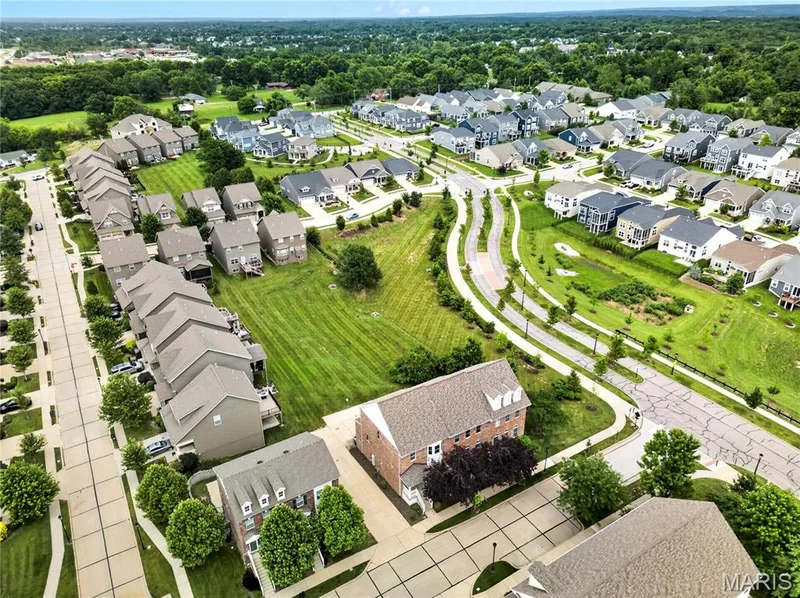 Aerial view of a residential neighborhood featuring varied single-family homes and townhomes — 2514 S Larksong Drive, Grover, MO 63040