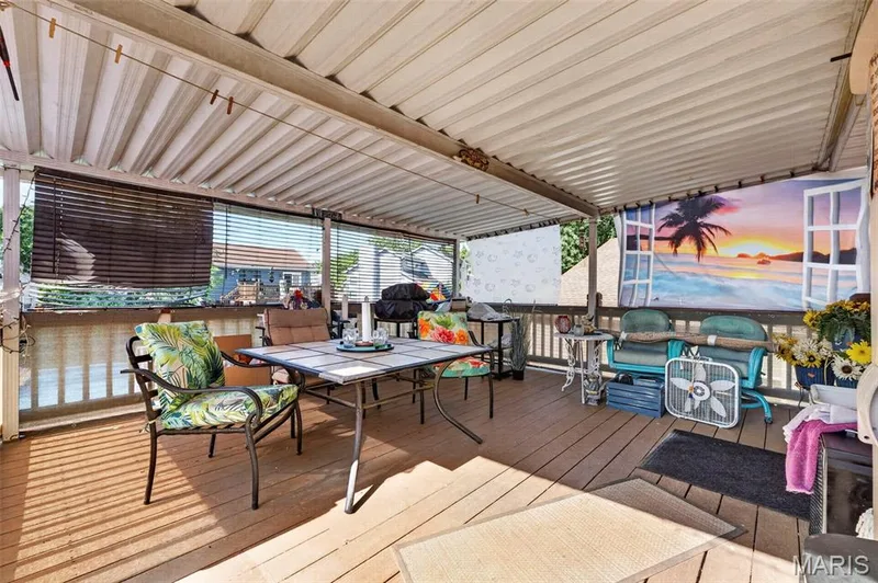 Covered outdoor patio with wood-finish flooring — 17 Kingspointe Court, St Peters, MO 63376