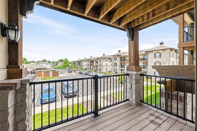 Private balcony featuring stone-wrapped columns, and black iron railings — 321 Bordeaux Way, St Peters, MO 63376