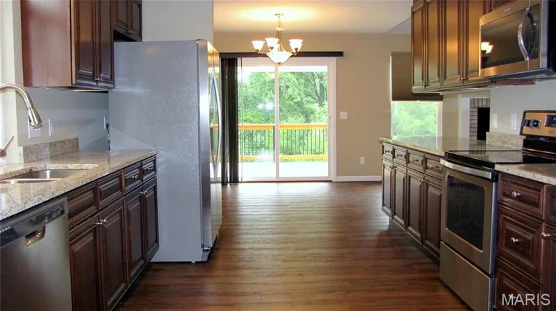 Looking from laundry room thru kitchen into dining area and deck. — 110 Fallon Villa Court, O'Fallon, MO 63368