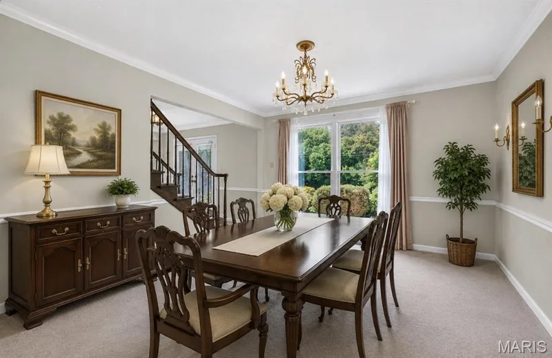 Formal dining area featuring neutral wall tones with chair rail and crown molding — 3672 Hawks Rest Road, Wildwood, MO 63069