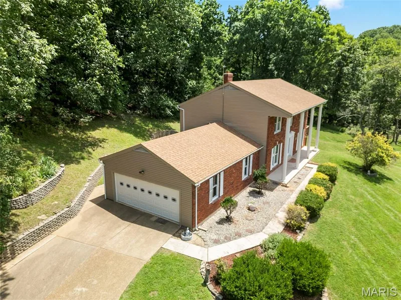 Brick and siding exterior with a shingle roof and white columns — 3672 Hawks Rest Road, Wildwood, MO 63069