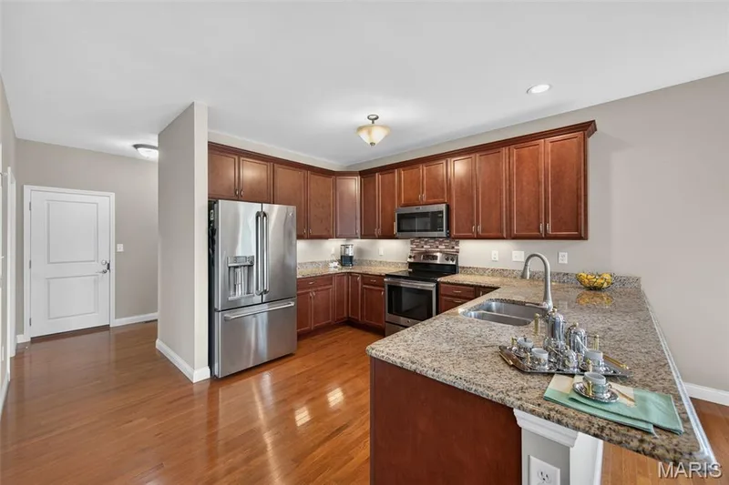 Kitchen featuring dark wood cabinetry — 1125 Duxbury Lane, O'Fallon, MO 63366