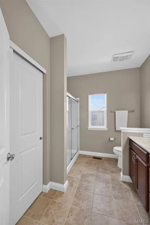 Primary bathroom with walk in shower and linen closet — 1125 Duxbury Lane, O'Fallon, MO 63366