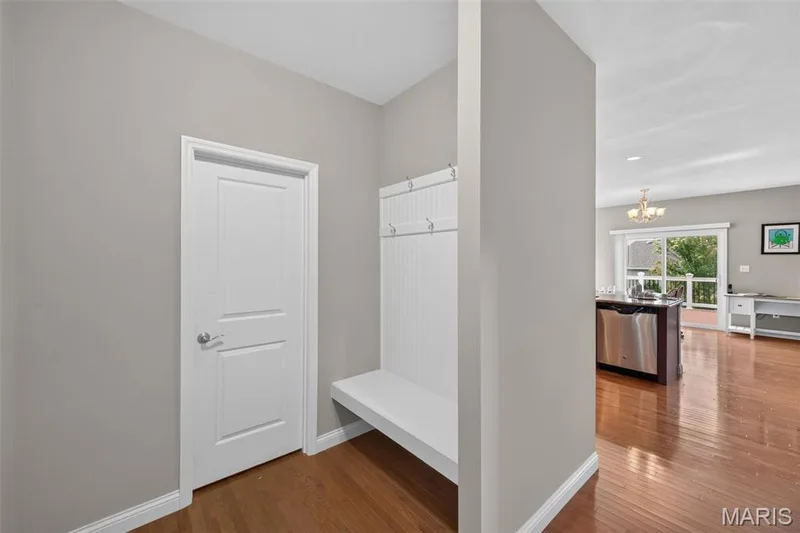 Built-in white bench with coat hooks provides functional organization — 1125 Duxbury Lane, O'Fallon, MO 63366