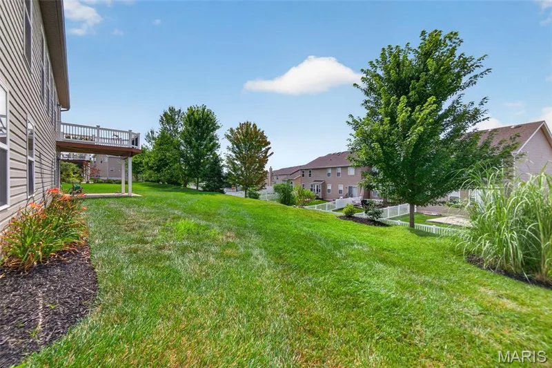 Expansive backyard featuring a lush lawn — 1125 Duxbury Lane, O'Fallon, MO 63366