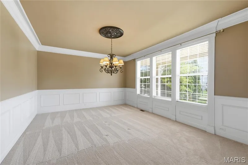 Spacious dining room with elaborate  millwork and crown molding — 5500 Wooded Creek Drive, O'Fallon, MO 63304