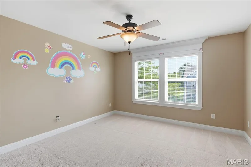 Bedroom with neutral-toned walls complement plush carpeting — 5500 Wooded Creek Drive, O'Fallon, MO 63304